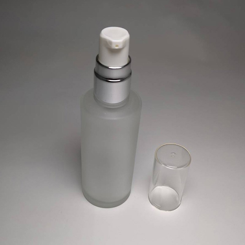 Best deal 50ml cylinder shape matte finish glass bottle 18/415 neck size with cosmetic lotion pump transparent cap